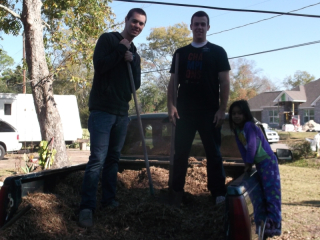 Unloading all the mulch from the truck with Elder Cope and Julia, their little grandaughter!